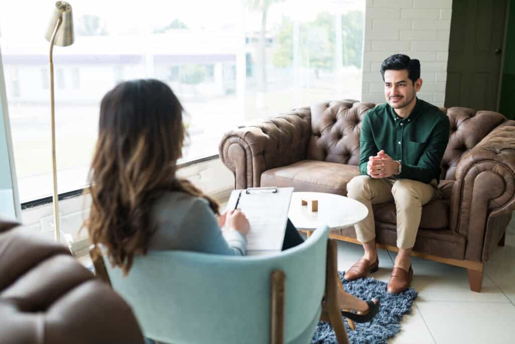 therapist and man meeting during an admission at a understanding the admissions process at a rehab in Merchantville, NJ
